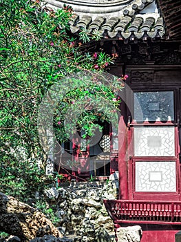 Traditional chinese building with ornate roof and red windows at Yu Gardens, Shanghai, China