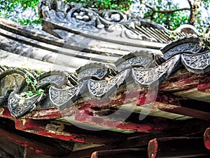 Traditional chinese building with ornate roof and red windows at Yu Gardens, Shanghai, China