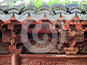 Traditional chinese building with ornate roof and red windows at Yu Gardens, Shanghai, China