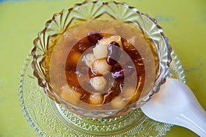 Traditional chinese dessert in longan syrup photo