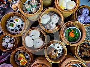 Traditional chinese dim sum steamed dumplings in the wooden plate on the table