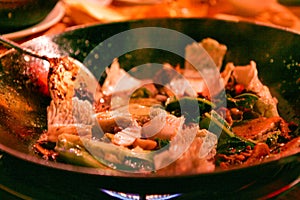 Traditional Chinese dish cooked in a wok pan over an open fire. Beijing, China.