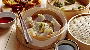 Traditional chinese dumplings served in the wooden bamboo steamer