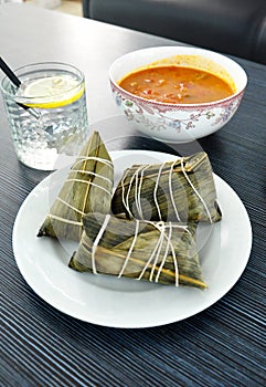 Traditional Chinese food, Dragon Boat Festival dumpling. Rice dumplings and sauce on wooden plate