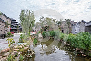 Traditional Chinese garden, a tourist attraction at Wolong College in Changting city, with ancient wood buildings, stones, and sma