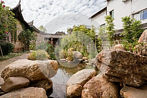 Traditional Chinese garden, a tourist attraction at Wolong College in Changting city, with ancient wood buildings, stones, and sma