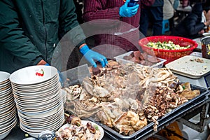 Traditional Chinese market stalls, steaming lamb soup, and haggis on a winter& x27;s day