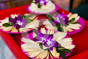 Traditional Chinese offerings to the gods in Taiwan with flowers and incense sticks