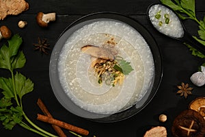 Traditional Chinese rice porridge with soft boiled egg, slice ginger and slice scallion topping for breakfast or light