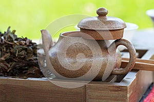 Traditional chinese tea ceremony accessories (tea pot) on the te photo