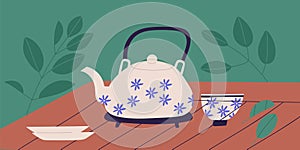 Traditional Chinese tea ceremony concept. Teapot with floral pattern, cup and saucers in retro style on wooden table