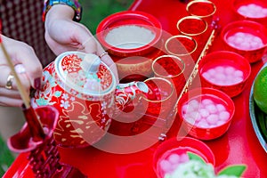 Traditional Chinese tea sets in wedding day. Pouring tea in a Chinese wedding. The Chinese text in the photo is pronounced Shuang