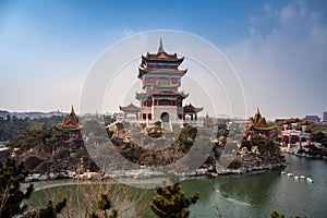 Traditional Chinese temple on the island in Penglai pavilion, Yantai, Shandong, China. Blue sky with copy space, wallpaper