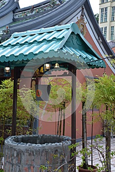 Singapore, old city Chinese temple well and bamboo plants