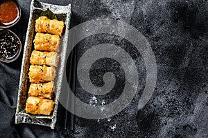 Traditional Chinese vegetable spring rolls. Vegetarian food. Black background. Top view. Copy space
