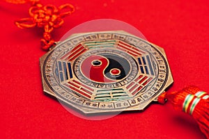 Traditional chinese yin and yang talisman on red surface
