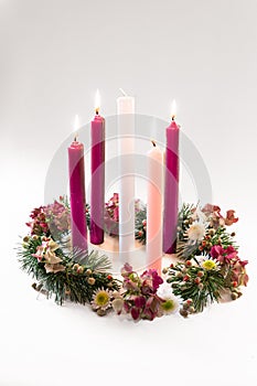 Traditional christian religious advent wreath with 5 candles, 4 candles burning