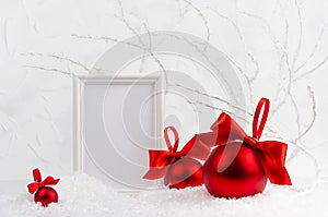 Traditional christmas background with blank photo frame mockup and rich sparkle red glossy balls with satin ribbons, bows in white