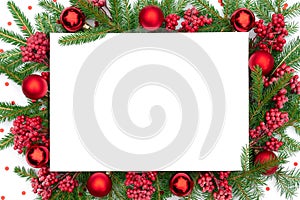 Traditional Christmas background with Christmas decorations in red colors. Christmas frame made of real spruce branches with