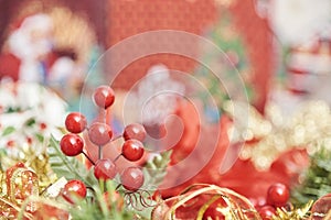 Traditional Christmas background. Red berries, ribbons and leaves in foreground
