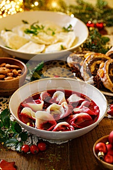 Traditional Christmas beetroot soup borsch with dumplings stuffed with mushrooms