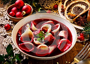 Traditional Christmas beetroot soup borsch with dumplings stuffed with mushrooms