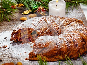 Traditional Christmas cake with dried fruits, raisins and nuts on wooden background.