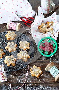 Traditional Christmas cookies with raisins on a rustic wooden background