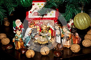 Traditional Christmas crib decorated under the Christmas tree.