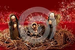 Traditional Christmas decoration. Nativity scene. Red background with lights