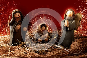 Traditional Christmas decoration. Nativity scene. Red background with lights