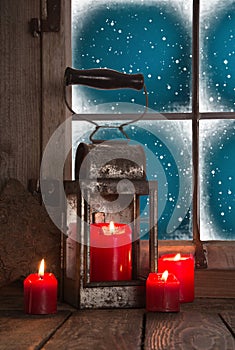 Traditional christmas decoration in red: four burning candles de