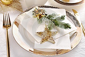 Traditional Christmas Eve wafer on elegant plate with fir and golden star