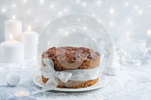 Traditional Christmas fruit cake on festive background