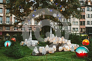 Traditional Christmas Market atmosphere and toys decorations in France with tourists having fun