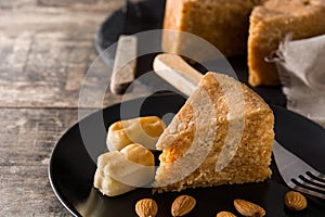 Traditional Christmas marzipan slice on wood