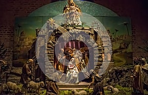 Traditional Christmas nativity scene with beautiful figures made out of wood. The birth of Jesus Christ in the manger surrounded