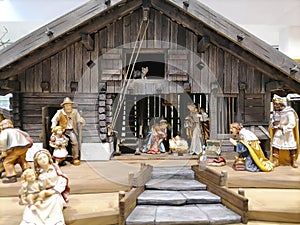 Traditional Christmas nativity scene with beautiful figures made out of wood. The birth of Jesus Christ in the manger surrounded