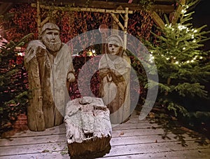 Traditional Christmas nativity scene with figures made out of wood, the birth of Jesus Christ in the manger surrounded by Joseph