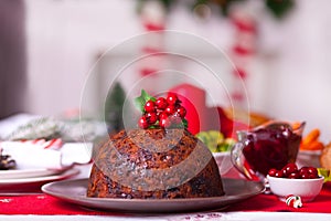 Traditional Christmas pudding with holly on top