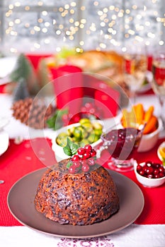 Traditional Christmas pudding with holly on top.