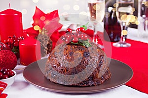 Traditional Christmas pudding with holly on top.