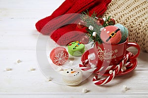 Traditional christmas themed french macaroons sweets in the form of snowman, snowflake, christmas tree and santa`s belly with can