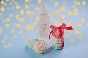 Traditional christmas themed french macaroons sweets in the form of snowman, snowflake, christmas tree and santa`s belly with can