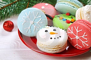 Traditional christmas themed french macaroons sweets in the form of snowman, snowflake, christmas tree and santa`s belly with can