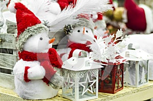 Traditional christmas toys figurines for home decor on new year. little toy  snowman, in red santa hat, candlestick