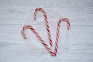 Traditional christmas tree decorations and festive treats, white and red three striped candy canes