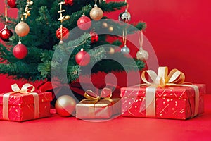 Traditional Christmas tree with star and balls and baubles on a red background