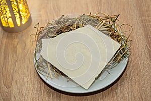 traditional Christmas wafer sitting on a bed of hay