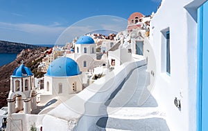 Traditional church and streets of Oia village, Santorini island, Greece